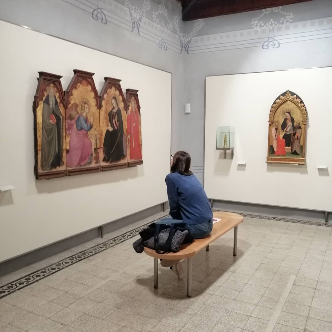 Visitor sitting on bench in the museum