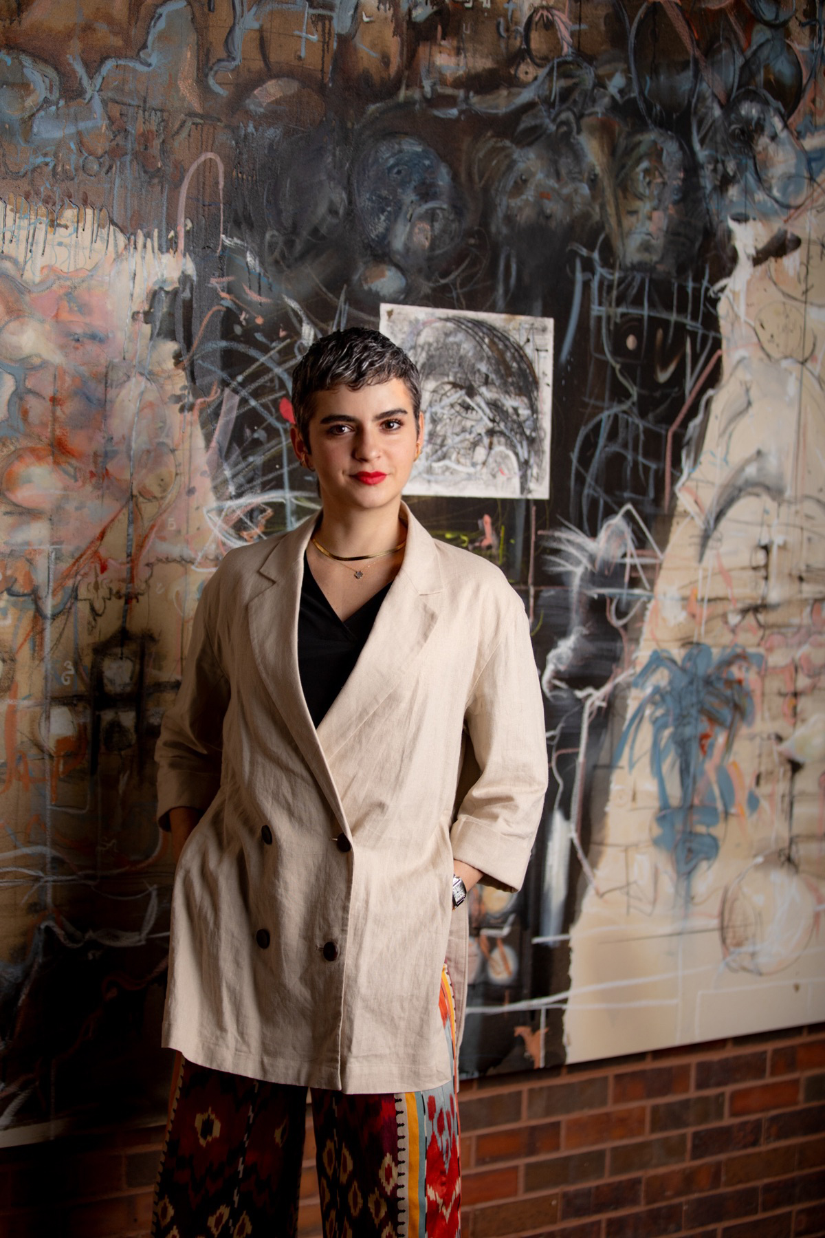 Vivian Zavataro standing in front of a painting