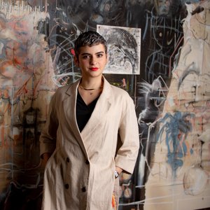 Vivian Zavataro standing in front of a painting